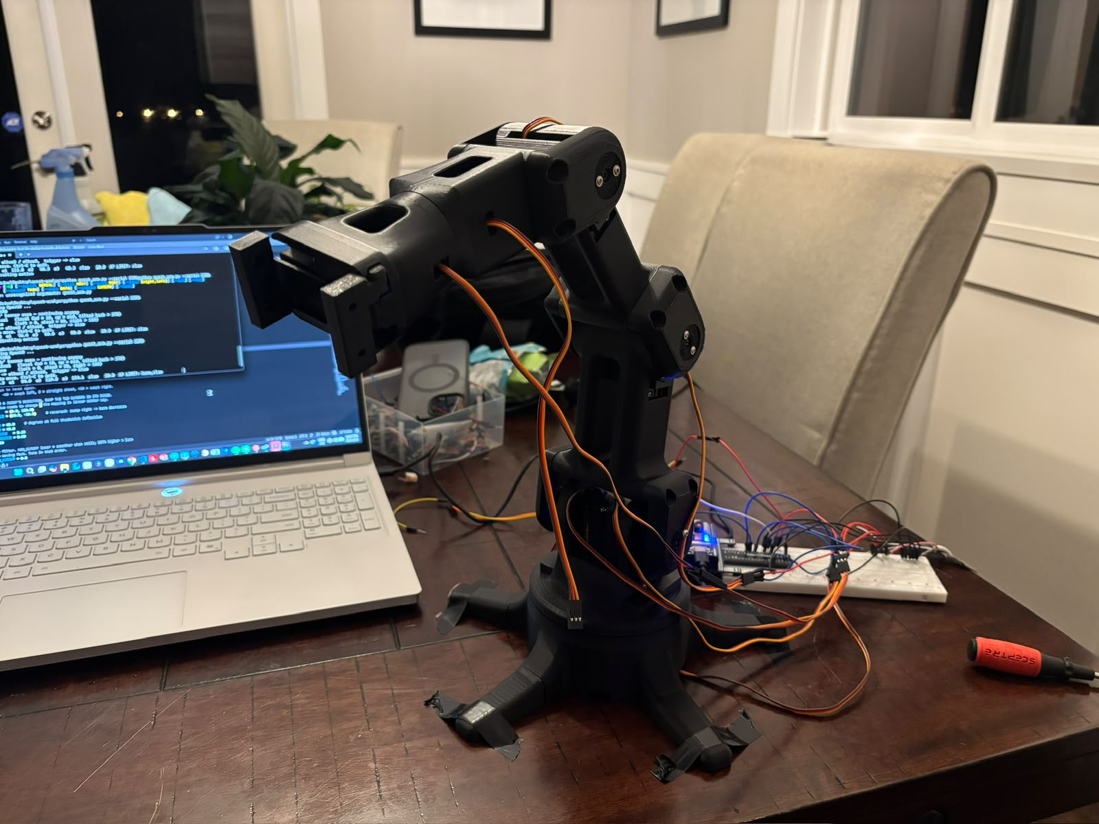 The 3D-printed robotic arm wired to an Arduino on a breadboard