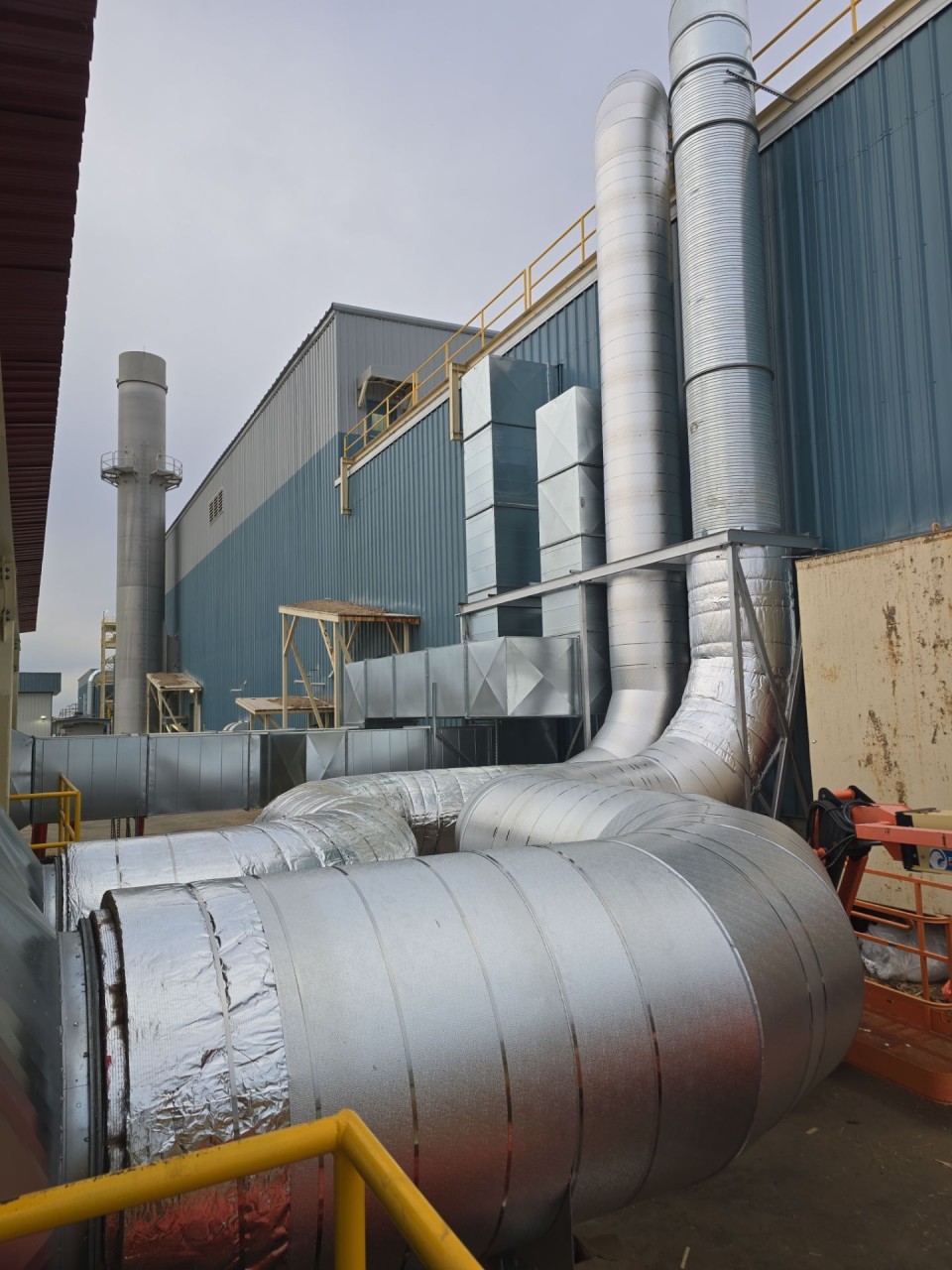 Rerouted insulated duct mains running between the buildings