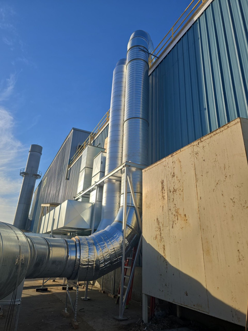 Vertical duct risers running up the building wall